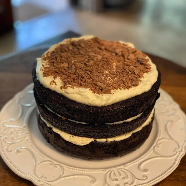 Three-layer chocolate cake with caramel filling and grated chocolate