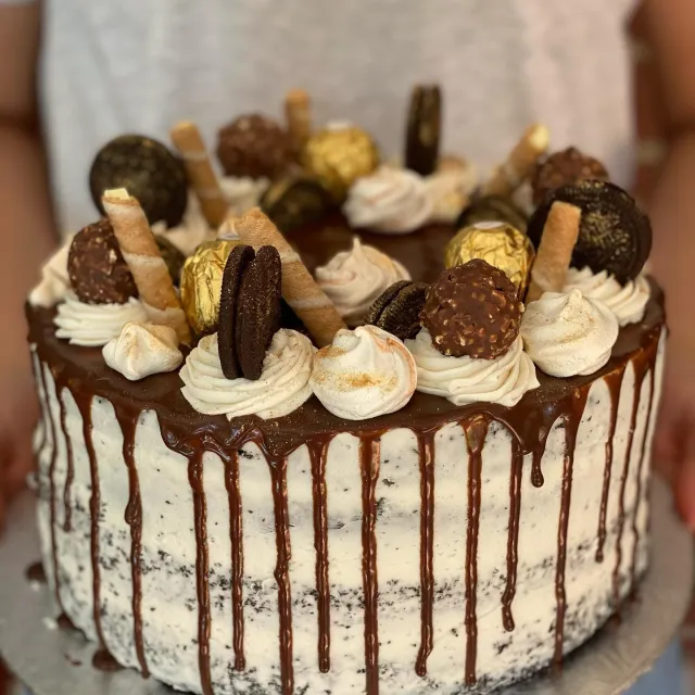 Naked cake with a chocolate drip, Ferrero Rochers and wafer rolls