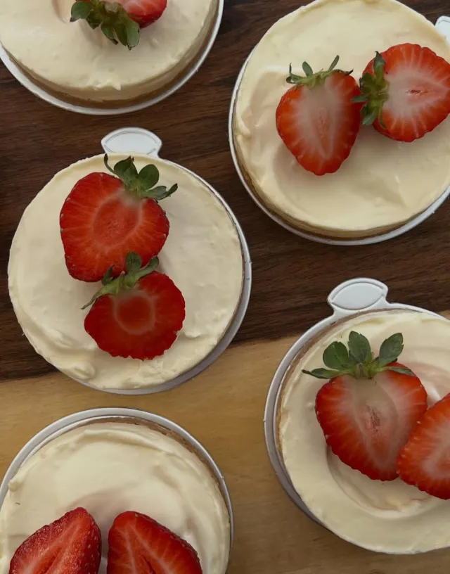 Mini cheesecakes topped with fresh strawberries
