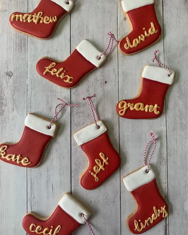 Christmas stocking cookies with names piped in gold