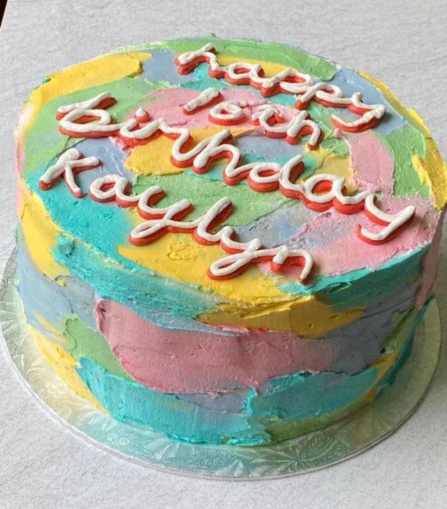 Pastel watercolour buttercream cake with piped birthday lettering